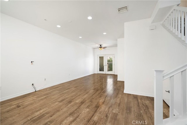 unfurnished living room with ceiling fan, french doors, and wood-type flooring