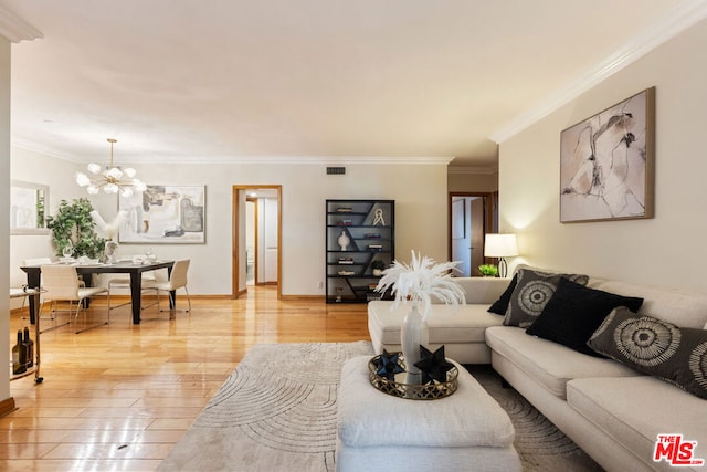 living room with an inviting chandelier, crown molding, and light wood-type flooring