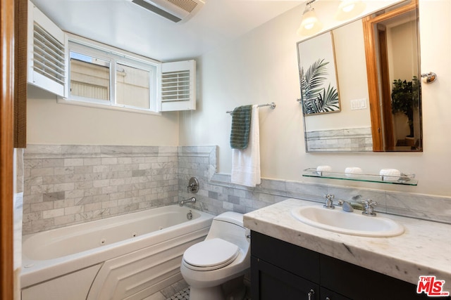 bathroom with vanity, a bath, and toilet