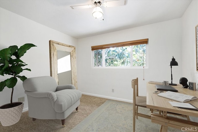 home office with ceiling fan and light carpet