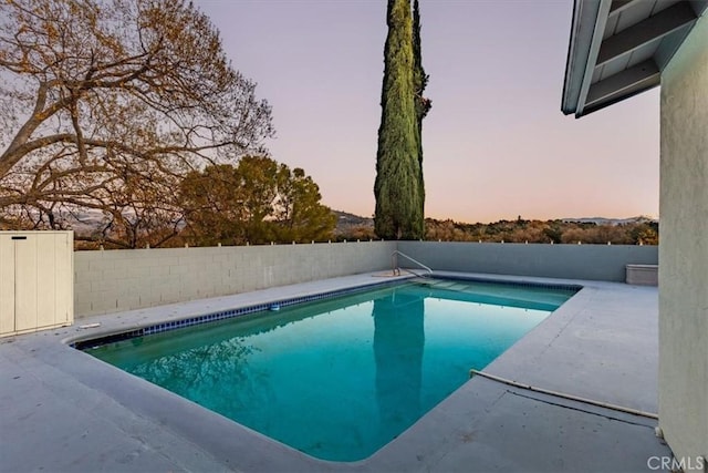 view of pool at dusk