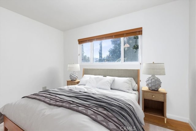 bedroom with hardwood / wood-style flooring