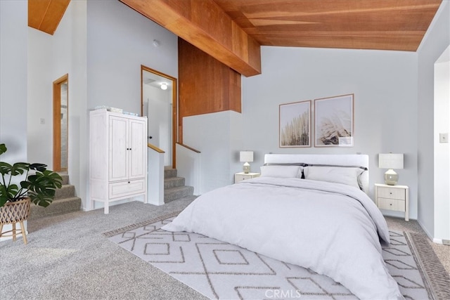 bedroom featuring carpet floors, high vaulted ceiling, and wood ceiling