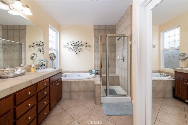 bathroom with tile patterned floors, vanity, and independent shower and bath