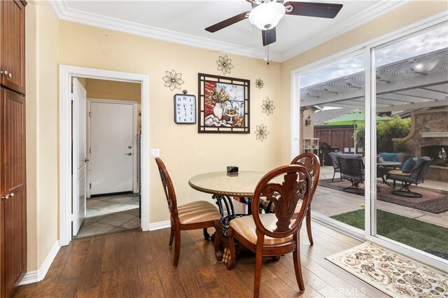 dining room featuring hardwood / wood-style flooring, ceiling fan, and ornamental molding