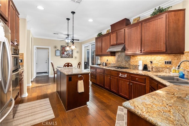 kitchen with a center island, sink, hanging light fixtures, dark hardwood / wood-style floors, and crown molding