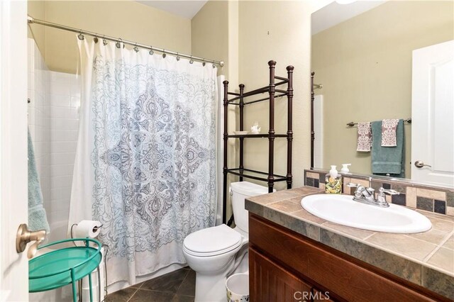 bathroom featuring tile patterned flooring, vanity, and toilet