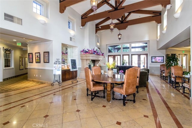 dining room with beam ceiling, light tile patterned floors, high vaulted ceiling, and crown molding