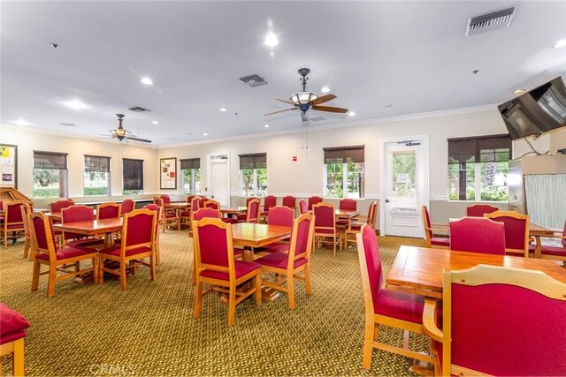 dining room featuring ornamental molding, ceiling fan, and a healthy amount of sunlight