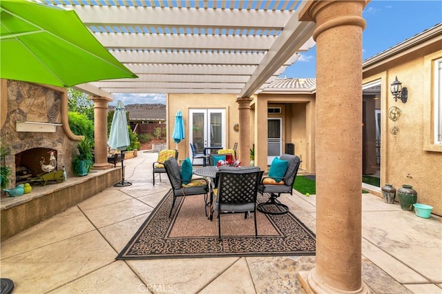 view of patio with an outdoor stone fireplace, outdoor dining area, and a pergola