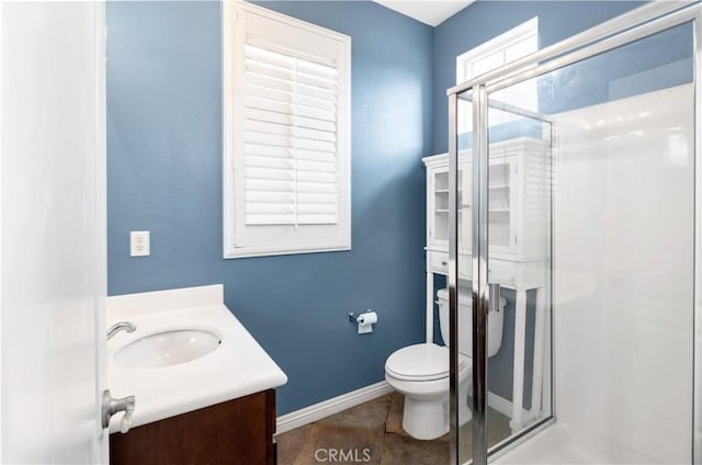 full bath featuring toilet, vanity, baseboards, a shower stall, and tile patterned floors