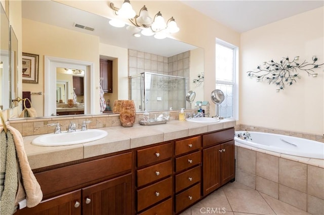 bathroom with tile patterned flooring, vanity, independent shower and bath, and a notable chandelier