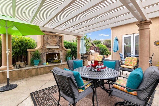 view of patio / terrace with a pergola, french doors, and an outdoor stone fireplace