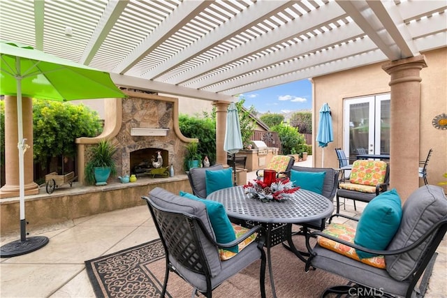 view of patio / terrace featuring an outdoor stone fireplace and outdoor dining area