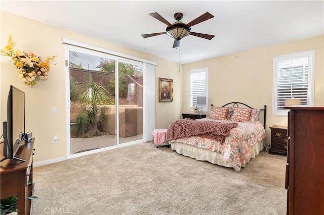 bedroom with access to exterior, ceiling fan, and light carpet