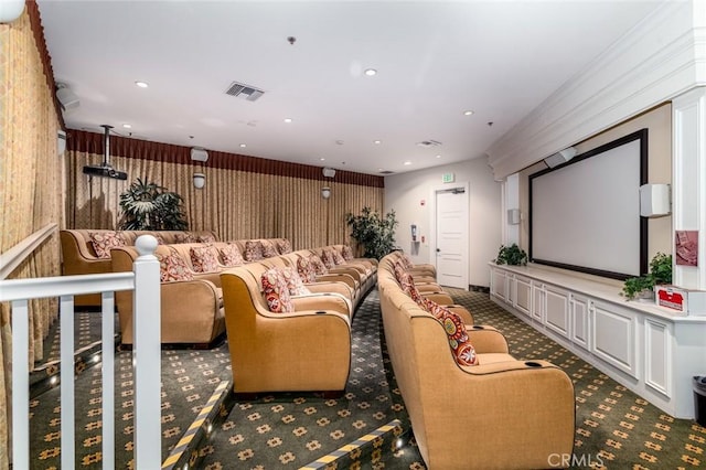 carpeted cinema room featuring ornamental molding