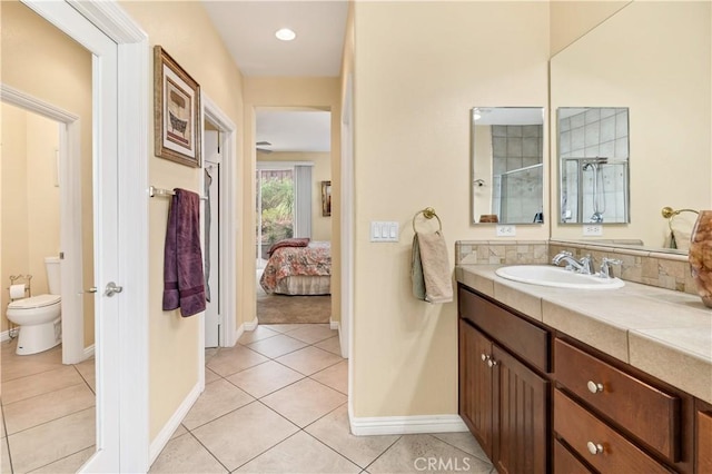 bathroom with baseboards, vanity, toilet, and tile patterned floors