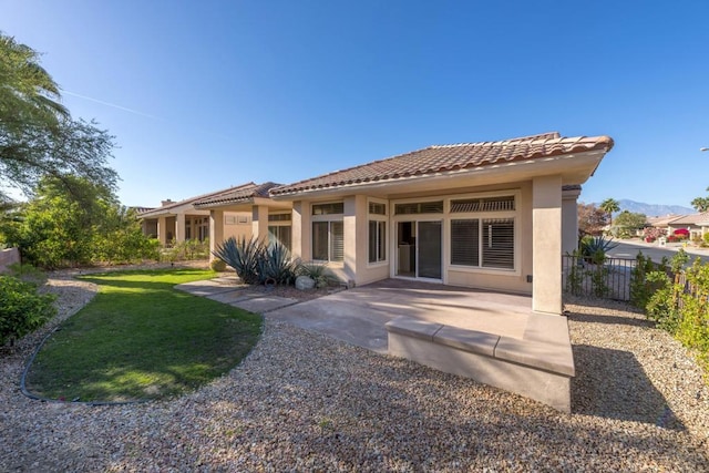 rear view of house with a patio area and a yard