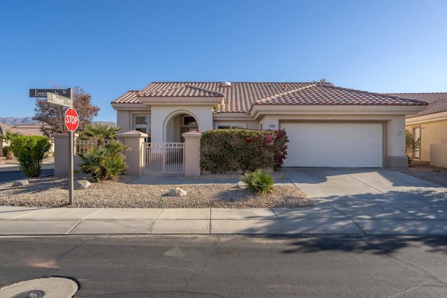 mediterranean / spanish-style home with a garage