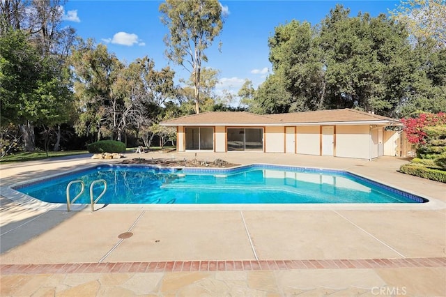 view of swimming pool with a patio area