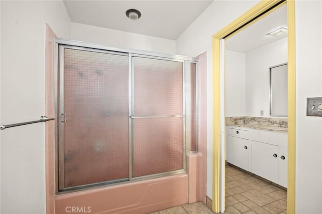 bathroom with vanity and bath / shower combo with glass door