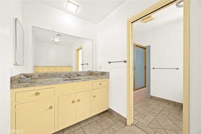 bathroom featuring vanity and enclosed tub / shower combo