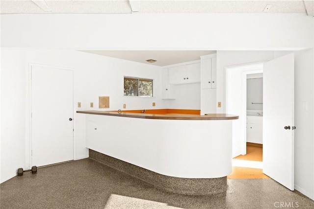 kitchen with white cabinets and kitchen peninsula