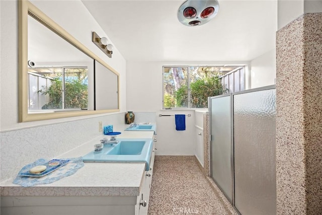 bathroom with vanity and a shower with shower door