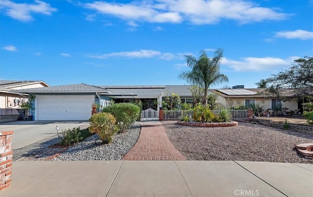 single story home featuring solar panels and a garage