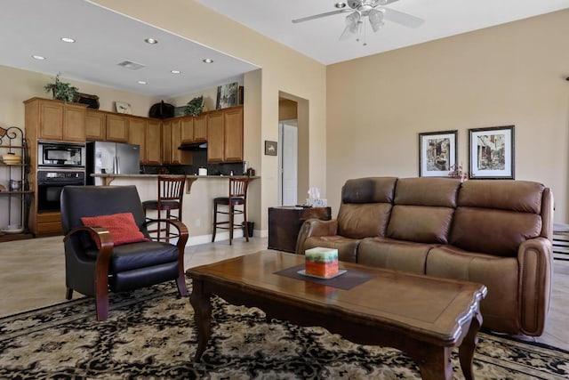 tiled living room with ceiling fan