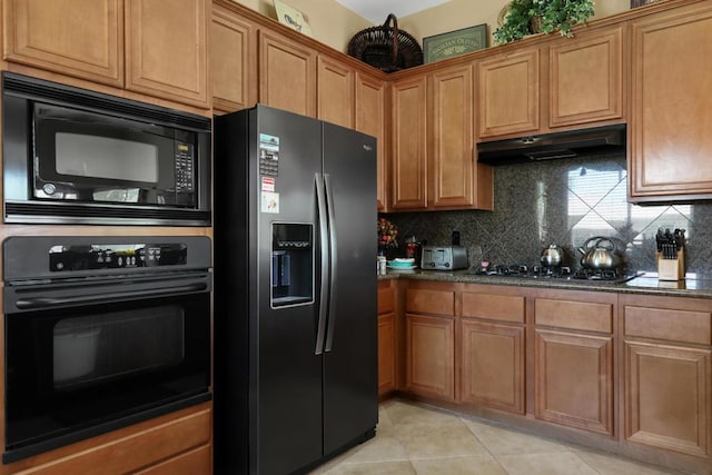 kitchen with tasteful backsplash, dark stone countertops, light tile patterned floors, and black appliances