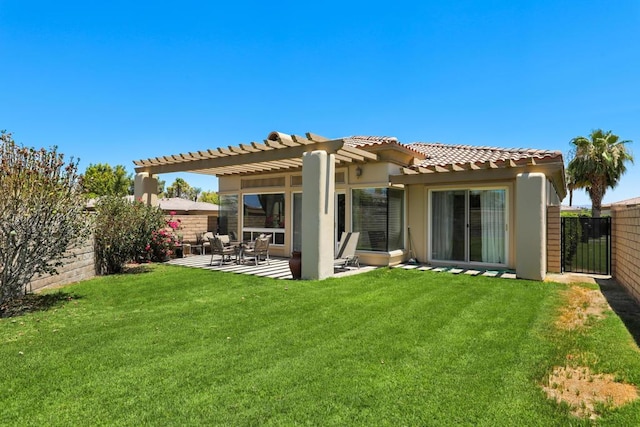 back of property featuring a yard, a pergola, and a patio