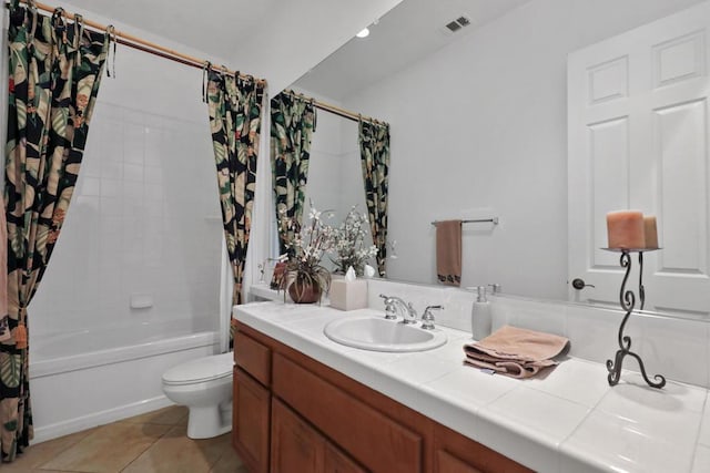 full bathroom featuring shower / tub combo with curtain, vanity, tile patterned flooring, and toilet