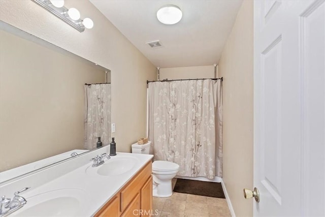 bathroom featuring tile patterned floors, vanity, and toilet