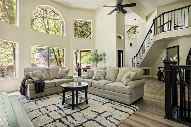 28670 Shenandoah Dr, Lake Arrowhead, CA 92352 - living room featuring a high ceiling, ceiling fan, plenty of natural light, wood finished floors, and stairway