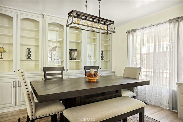28670 Shenandoah Dr, Lake Arrowhead, CA 92352 - dining space with light wood-style floors, built in shelves, and a chandelier