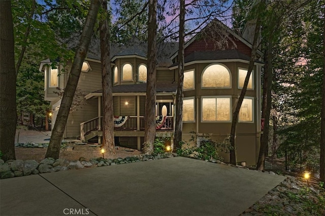 28670 Shenandoah Dr, Lake Arrowhead, CA 92352 - back of house featuring a patio and roof with shingles