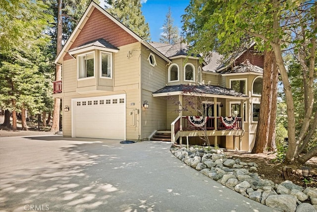 28670 Shenandoah Dr, Lake Arrowhead, CA 92352 - view of front facade with driveway, a garage, and a shingled roof