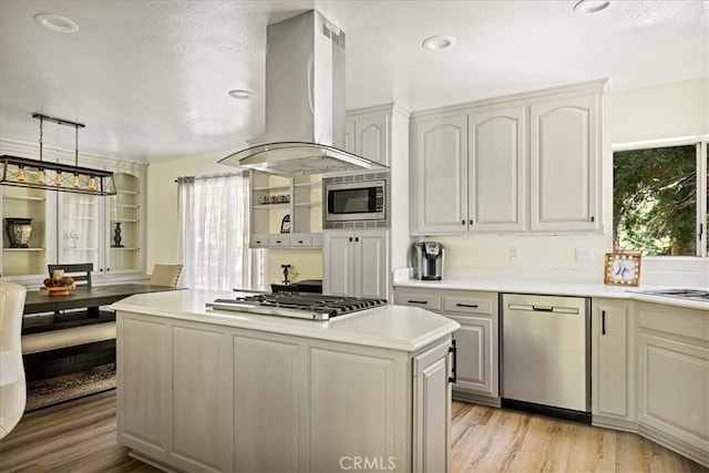 28670 Shenandoah Dr, Lake Arrowhead, CA 92352 - kitchen with appliances with stainless steel finishes, island exhaust hood, healthy amount of natural light, light countertops, and a textured ceiling