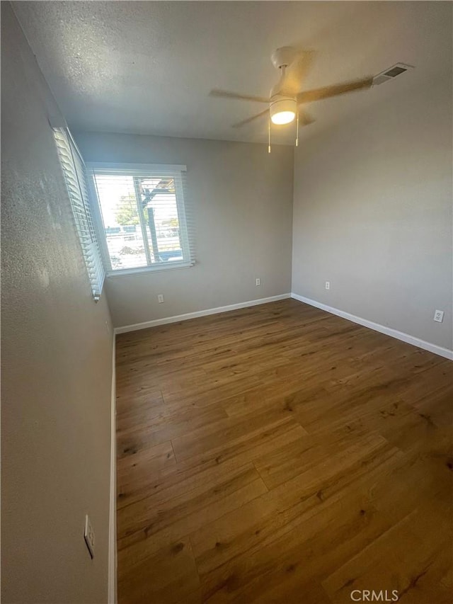 unfurnished room with hardwood / wood-style flooring and ceiling fan