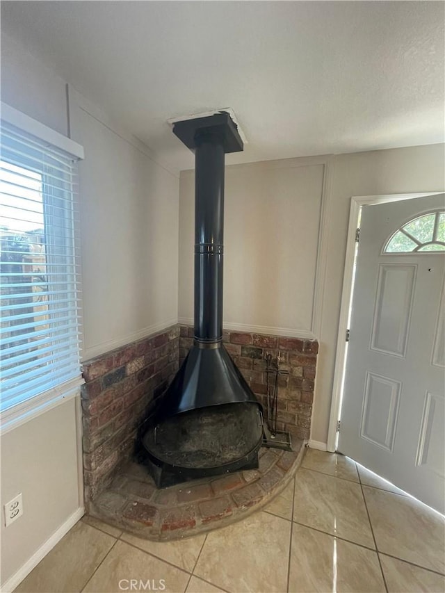 room details featuring a textured ceiling and a wood stove