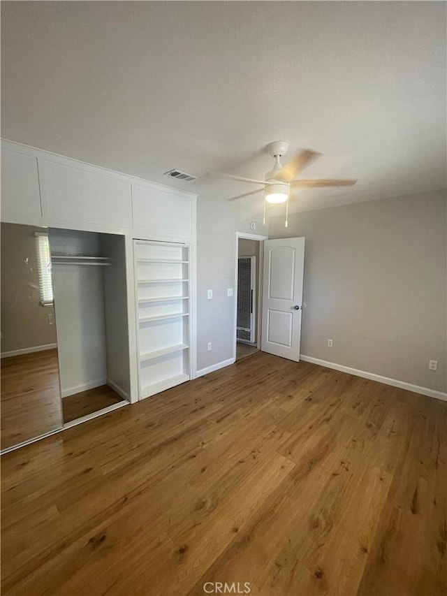 unfurnished bedroom with ceiling fan, a closet, and light hardwood / wood-style flooring