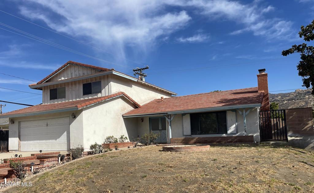 rear view of house with a garage