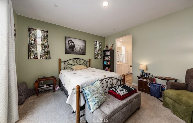 carpeted bedroom with connected bathroom