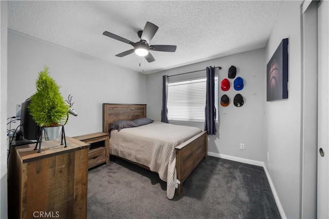 carpeted bedroom with ceiling fan and a textured ceiling