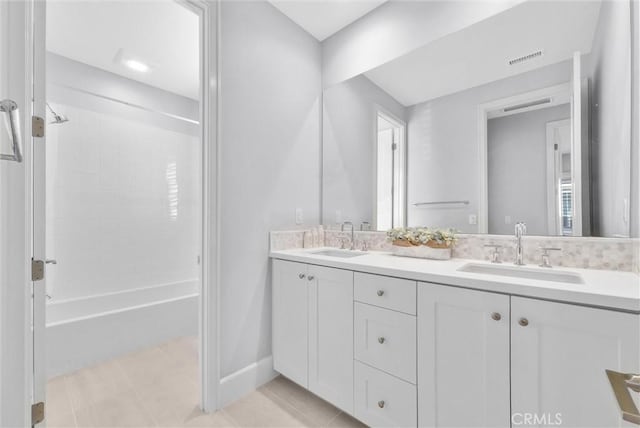 bathroom featuring vanity, tile patterned floors, and  shower combination