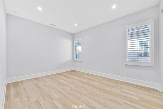 unfurnished room with light hardwood / wood-style flooring