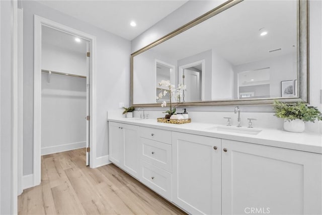 bathroom featuring vanity and wood-type flooring