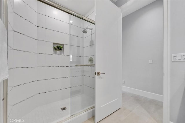 bathroom featuring a shower with door and tile patterned flooring