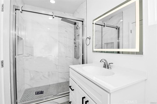 bathroom with an enclosed shower and vanity